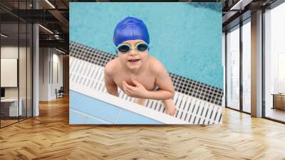 close up photo of a 7-year boy playing and swimming in the swimming pool Wall mural