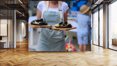 Waiter holding two plates with tasty mussels Wall mural