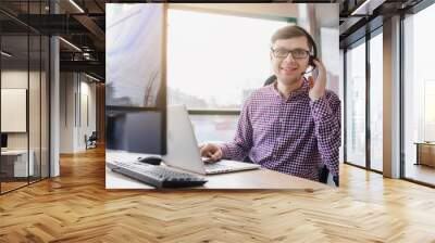 Young handsome man with casual shirt and glasses, happy businessman Wall mural