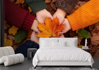 Family holding hands in a circle of love and gratitude, celebrating Thanksgiving outdoors with a picturesque autumn backdrop.  Wall mural