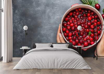 Hands mixing cranberry sauce in a pot, vibrant red color and fresh cranberries visible, Tart and sweet Thanksgiving condiment, Festive cooking. Wall mural