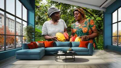 Two farmers have a conversation during the cocoa pod harvest, production of chocolate in Africa Wall mural