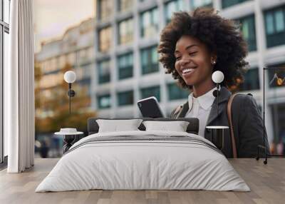 Happy busy young African American business woman using mobile phone outdoors. Smiling female professional holding smartphone walking at city street looking at cell working outside, Generative AI Wall mural