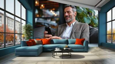 Happy smiling confident mid aged business man, mature professional businessman sitting in outdoor office holding smartphone using mobile phone digital, Generative AI Wall mural