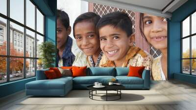 Group of Indian siblings smiling and looking at the camera Wall mural