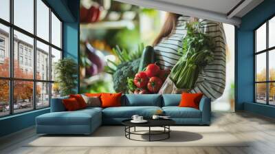 A pregnant woman stands in front of a vegetable stand. The vegetables include broccoli, tomatoes, and cucumbers Wall mural