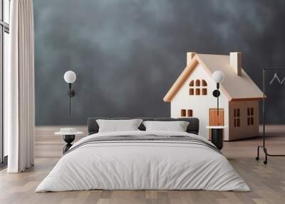 A small wooden house is sitting on a wooden table. The house is made of wood and has a simple design. The scene is peaceful and calming Wall mural