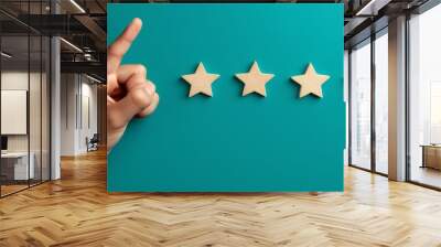 Hand with pointing finger pointing to rating stars , Customer service evaluation and satisfaction survey concepts.  Wall mural