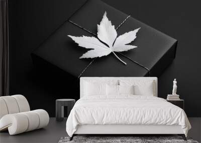 Minimalist, black gift box with a single, white leaf silhouette.  Wall mural