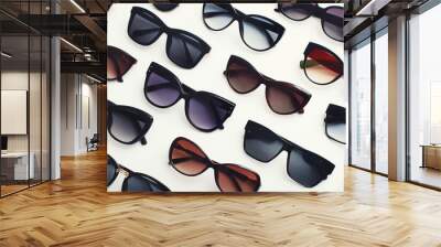 Trendy sunglasses on white background. Diagonal arrangement with different stylish accessories. Selective focus. Wall mural