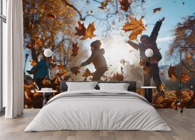 A dynamic shot of children playing in a pile of leaves in a sunny park, with leaves mid-air and smiles capturing the joy and playfulness of autumn Wall mural