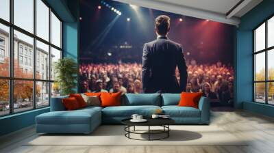 Back view of motivational speaker standing on stage in front of audience for motivation speech on conference or business event Wall mural