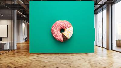 Circular statistical graphic made of doughnuts on green background, comparison chart concept Wall mural