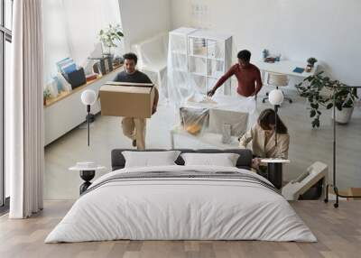 High angle view of business people packing things and furniture while moving in new office Wall mural