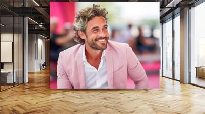 A man in a pink suit is smiling and looking at the camera Wall mural