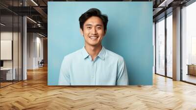 A man with a blue shirt and a smile on his face Wall mural