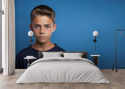 A young boy with a blue shirt and brown hair Wall mural