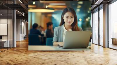 young asian business woman using digita tablet and working on laptop computer at modern office. Wall mural