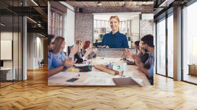 Business people looking at projector during video conference in office Wall mural