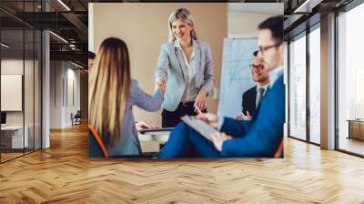 Business shaking hand with a client in office Wall mural