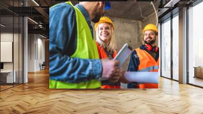 Construction team planning a building blueprint project on site with collaboration for architect innovation. Architecture, design and engineers with teamwork for successful industrial renovation. Wall mural