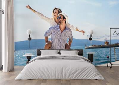 Couple in love, enjoying the summer time by the sea. Wall mural