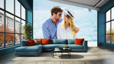 Couple in love, enjoying the summer time by the sea. Wall mural