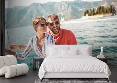 Couple in love on a sail boat in the summer. Wall mural