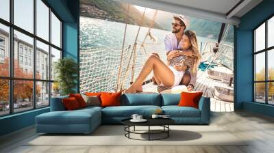 Couple in love on a sail boat in the summer. Wall mural