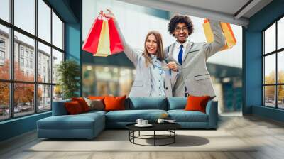 Couple in shopping. Happy couple with shopping bags and credit card enjoying in shopping. Wall mural