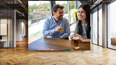 Group of friends chilling at the cafe. Talking, drinking coffee and orange juice. Wall mural