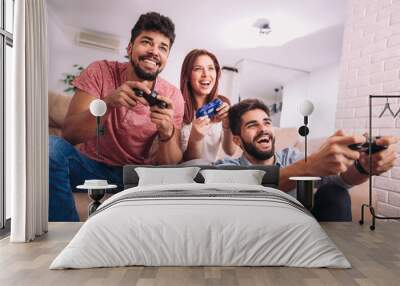 Group of friends play video games together. Wall mural