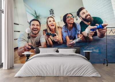 Group of friends play video games together. Wall mural