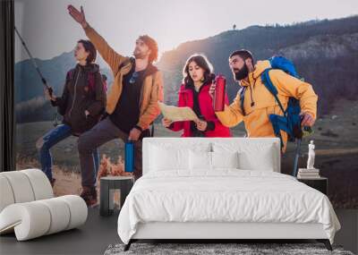 Group of hikers walking on a mountain at autumn day Wall mural