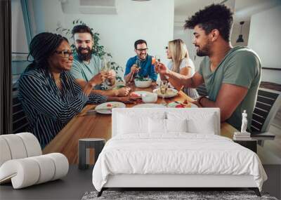 Group of multiethnic friends enjoying dinner party Wall mural