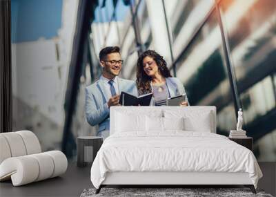 Handsome man and beautiful woman as business partners using digital tablet outdoor Wall mural