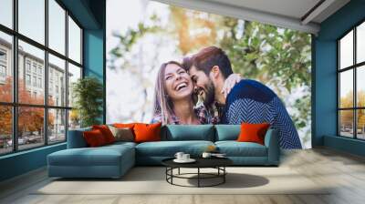 Happy couple in love having fun outdoors and smiling. Wall mural