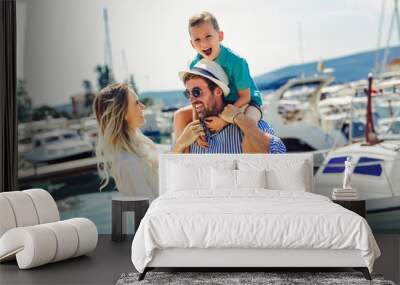 Happy family having fun, enjoying the summer time by the sea. Wall mural