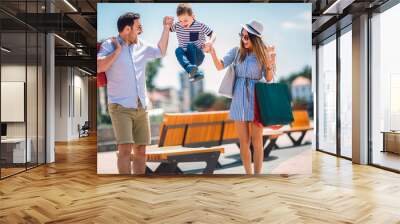 Happy family having fun outdoor after shopping Wall mural