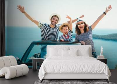 Happy family travel by car to the sea. People having fun in cabriolet. Summer vacation concept Wall mural