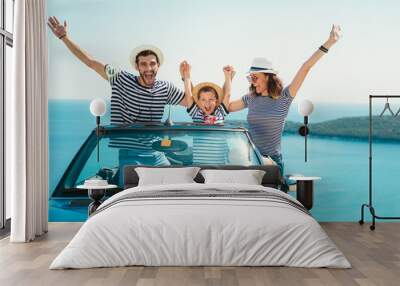 Happy family travel by car to the sea. People having fun in cabriolet. Summer vacation concept Wall mural