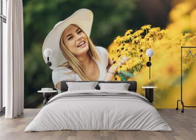 Happy smiling pretty young woman with spring flowers Wall mural