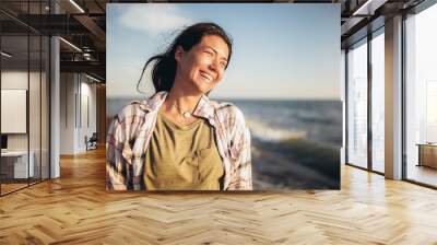 Happy woman on the beach. Portrait of the beautiful girl close-up, the wind fluttering hair. S Wall mural