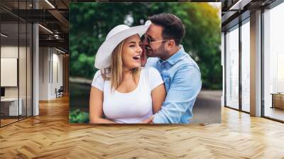 Happy young couple having fun outdoors and smiling. Wall mural