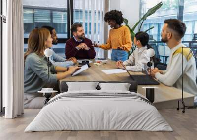 International workers group and team leader having teamwork discussion managing project at work in meeting room. Wall mural