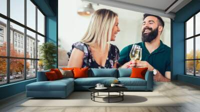 Smiling couple dating and drinking wine at home Wall mural