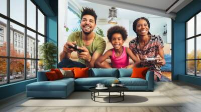 Smiling family sitting on the couch together playing video games Wall mural