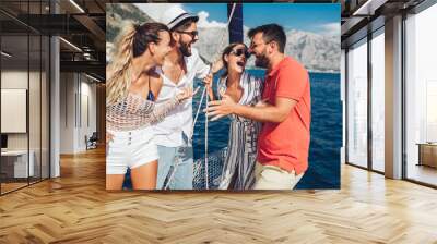 Smiling friends sailing on yacht - vacation, travel, sea, friendship and people concept Wall mural