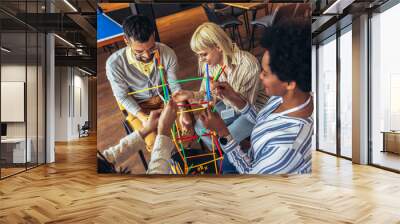 Team building activities in the office with sticks.Concept of friendship, teambuilding and teamwork. Wall mural