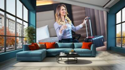 Young attractive businesswoman in hotel room Wall mural